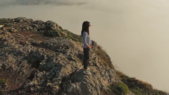 Positive Woman On The Edge Smiles Above Clouds alt