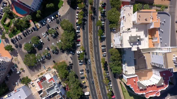 Topdown Aerial View of the Roofs of the Road and Streets Between Small Colorful Houses in the Center alt