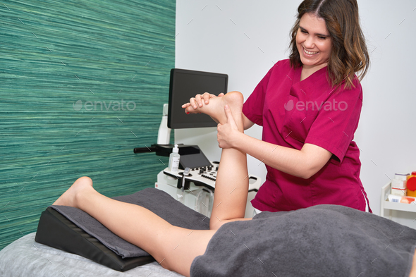 Physiotherapist treating patient\'s foot injury