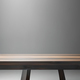 A wooden bench with a light on it and a gray wall behind it. - PhotoDune Item for Sale