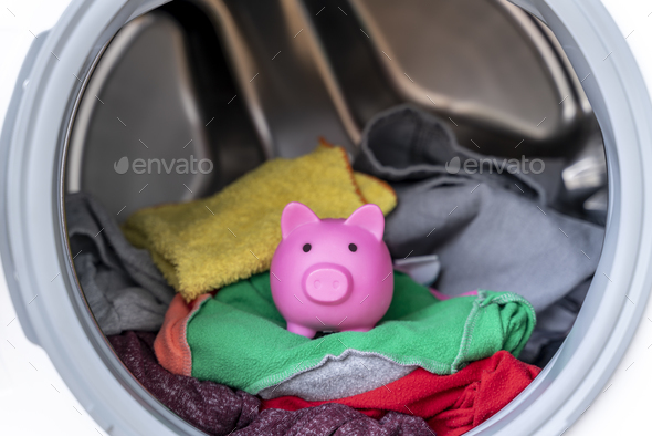Concept of saving electricity with a washing machine with a piggy bank inside