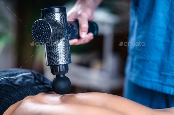 Massage Gun Treatment. Physical Therapist Massaging Man's Lower