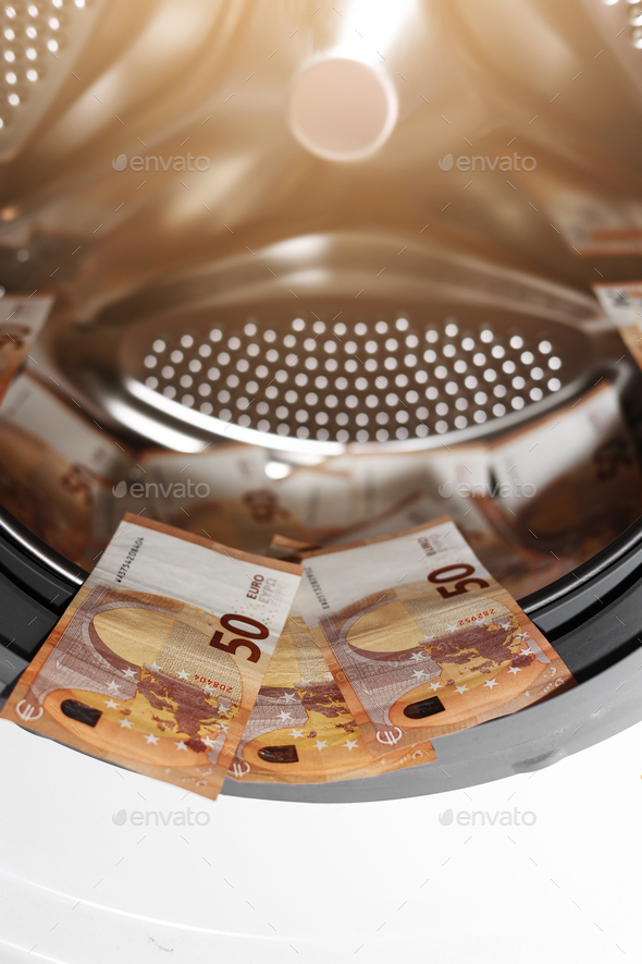 Euro money banknotes in washing machine - illegal cash 50 and mafia money laundering - tax evasion