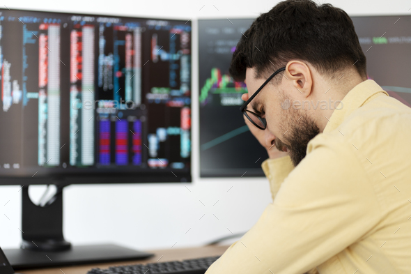 Tired overworked bearded man, trader having headache, lost money sitting in office, selective focus