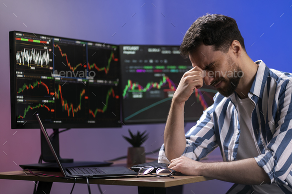 Tired crypto trader having headache, lost money, working late night. Failure business, bankruptcy