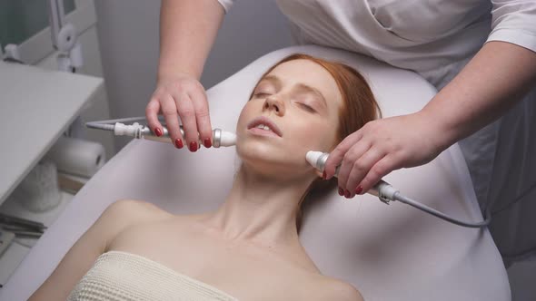 Young Woman in the Cosmetologist's Office Will Receive the Facial Skin Rejuvenation Procedure alt