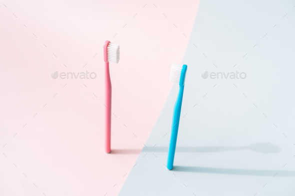Toothbrushes on the background of gender colors - Stock Photo - Images