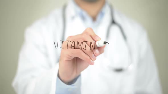 Vitamin C, Doctor Writing on Transparent Screen alt