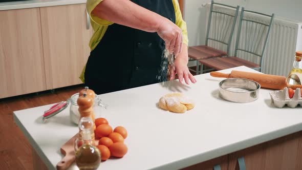 Retired Woman Cooking on Wooden Table alt