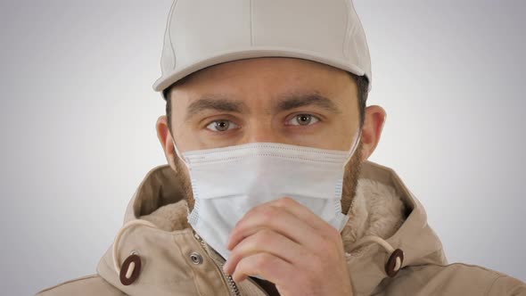 Coughing Casual Man in Medical Mask on Gradient Background alt