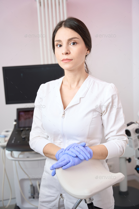 Female gynecologist is standing in the clinic office Stock Photo by ...