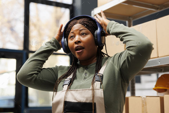 African american worker enjoying listening music - Stock Photo - Images