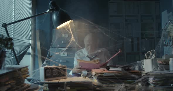 Businessman searching for files in his abandoned office