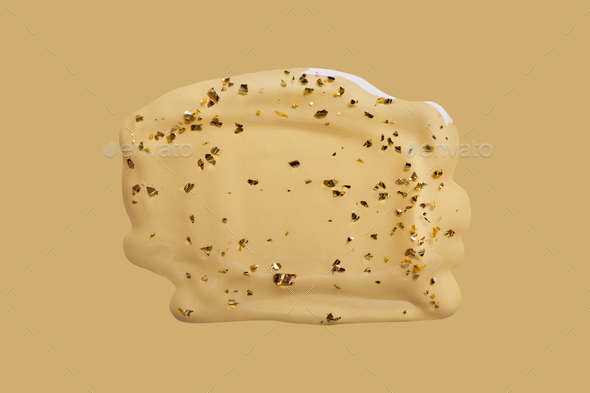 Liquid cosmetic gel swatch with gold particles on beige background. Anti-Aging Serum Sample