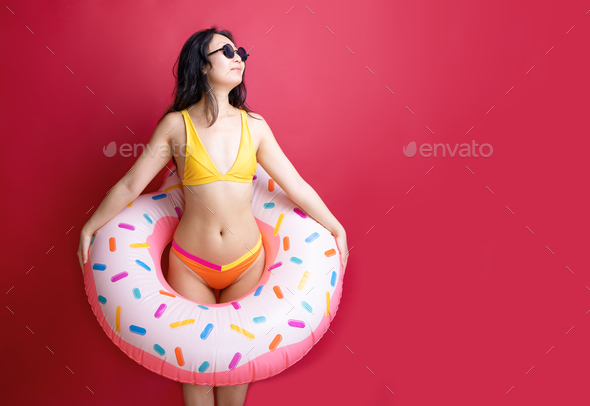 Happy fun young sexy asian woman slim body wear swimsuit hold pink  inflatable ring isolated on vivid Stock Photo by nikolast1