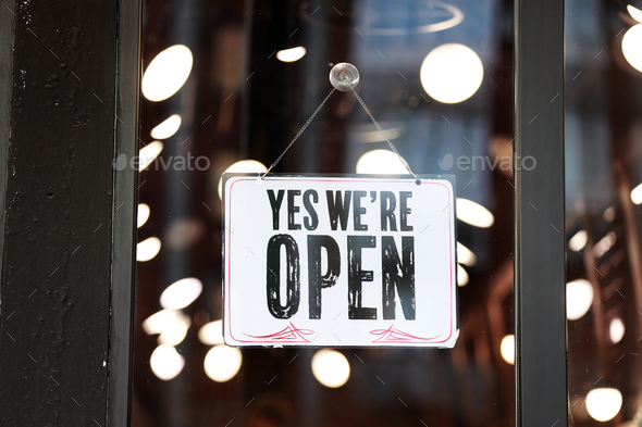 Inscription Yes we\'re open metal plate with black and white sign on glass door store, cafe, beautys