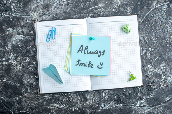 top view always smile note on open copybook on a gray background study note college school notepad