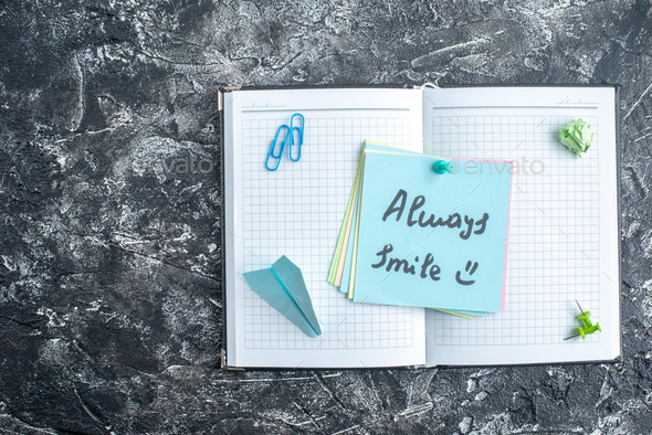 top view always smile note on open copybook on gray background study note college school lesson