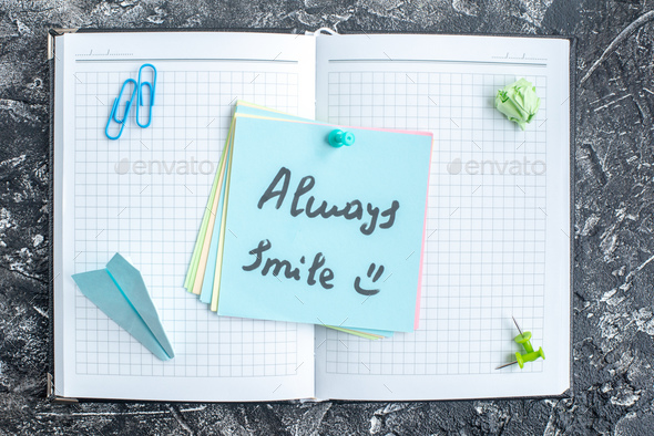 top view always smile note on open copybook on gray background study note college school notepad