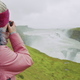 Tourist woman looking at Gullfoss waterfall the famous attraction and landmark destination on - PhotoDune Item for Sale