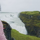 Tourist woman looking at Gullfoss waterfall the famous attraction and landmark destination on - PhotoDune Item for Sale