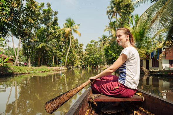 Tourist woman boating on Alleppey backwaters and enjoyin beautiful view - Stock Photo - Images