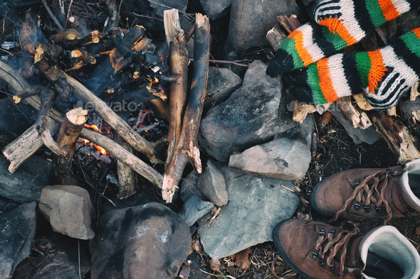 Knitted socks and hiking boots drying near a campfire - Stock Photo - Images