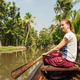 Tourist woman boating on Alleppey backwaters and enjoyin beautiful view - PhotoDune Item for Sale