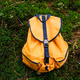 Orange tourist backpack in the forest on green moss - PhotoDune Item for Sale