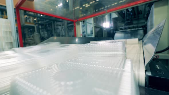 Batches of Plastic Containers are Getting Removed From the Transporter alt