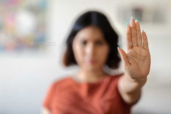 Stop Domestic Violence. Serious Young Woman Showing Open Palm Gesture At Camera