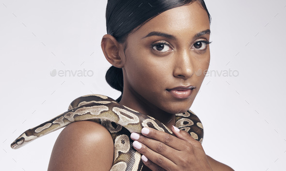 Beauty, nature and portrait of woman with snake on neck for art aesthetic with exotic zoo animal on
