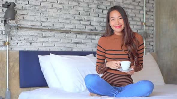 Young asian woman with coffee cup alt