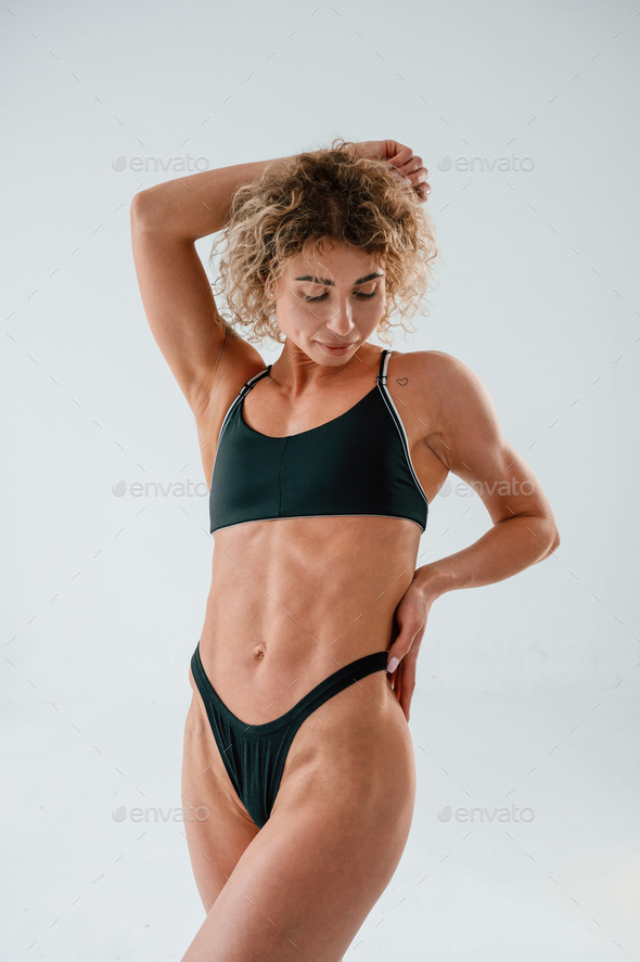 Beautiful abs. Young caucasian woman with athletic body shape is