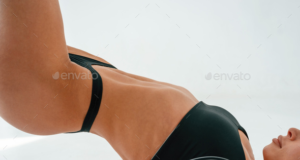 Young caucasian woman with athletic body shape is indoors at daytime Stock  Photo by mstandret