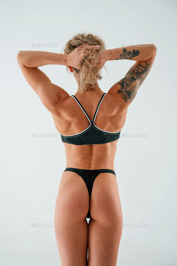 Young caucasian woman with athletic body shape is indoors at daytime Stock  Photo by mstandret