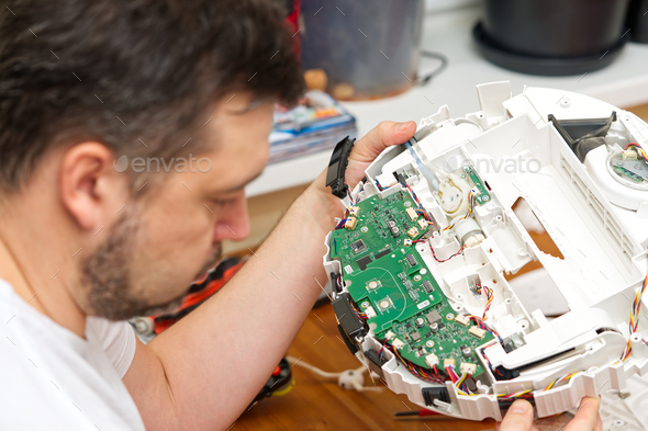 home electronics repair concept. vacuum robot cleaner service center