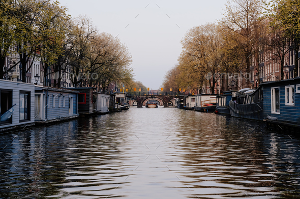 Aesthetic canals of Amsterdam at sunset, view from the water