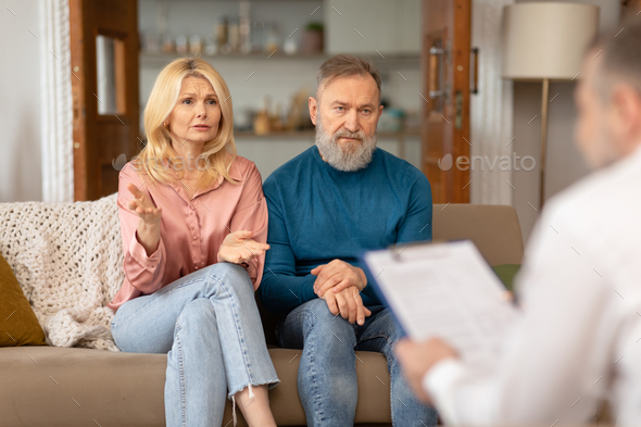 Unhappy Couple Consulting With Professional Psychologist Having Relationship Crisis Indoors