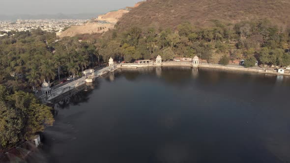 Udaipur lake Pichola bank surrounded by stone dam in Rajasthan, India - Aerial Panoramic shot alt
