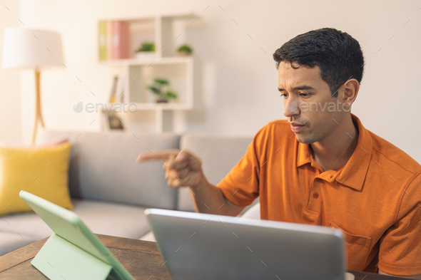 Angry man pointing during a work online meeting at home