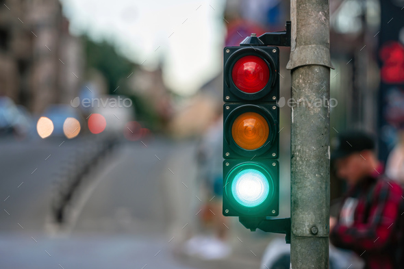 traffic light on the street junction with beautiful bokeh, city with cars in the background - Stock Photo - Images