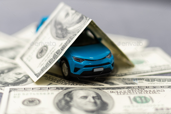 Toy car and money over white. Rent, buy or insurance car concept