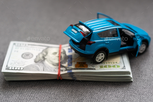 car and money. concept of car, Rent, car insurance, Toy car and money over white.