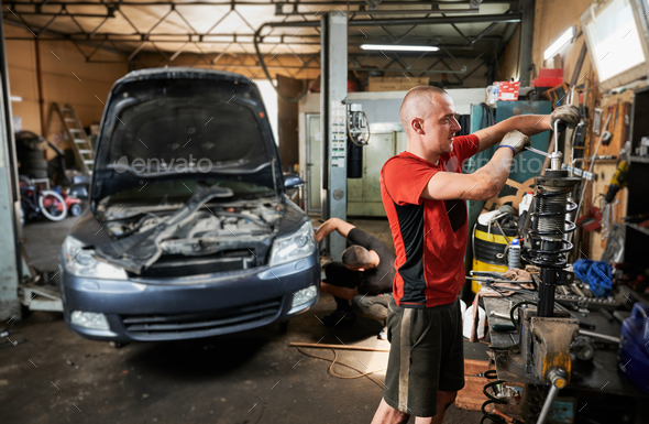 Professional mechanic, repairman, worker holding screwdriver