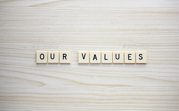Our Values letter tiles on a wood grain background - Stock Photo - Images