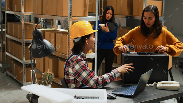 Asian employee doing stock logistics on laptop