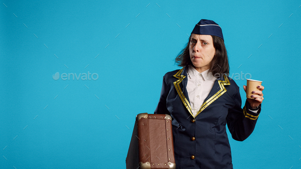 Smiling air hostess carrying suitcase to leave for work
