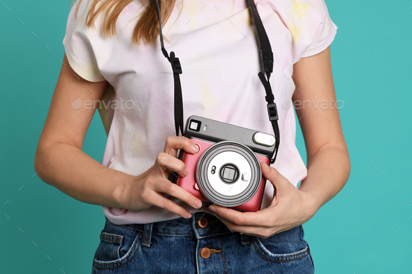Young woman with instant camera - Stock Photo - Images