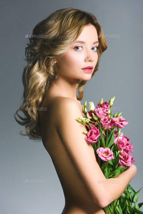 Beautiful Naked Girl Holding Bouquet Of Eustoma Flowers Isolated On